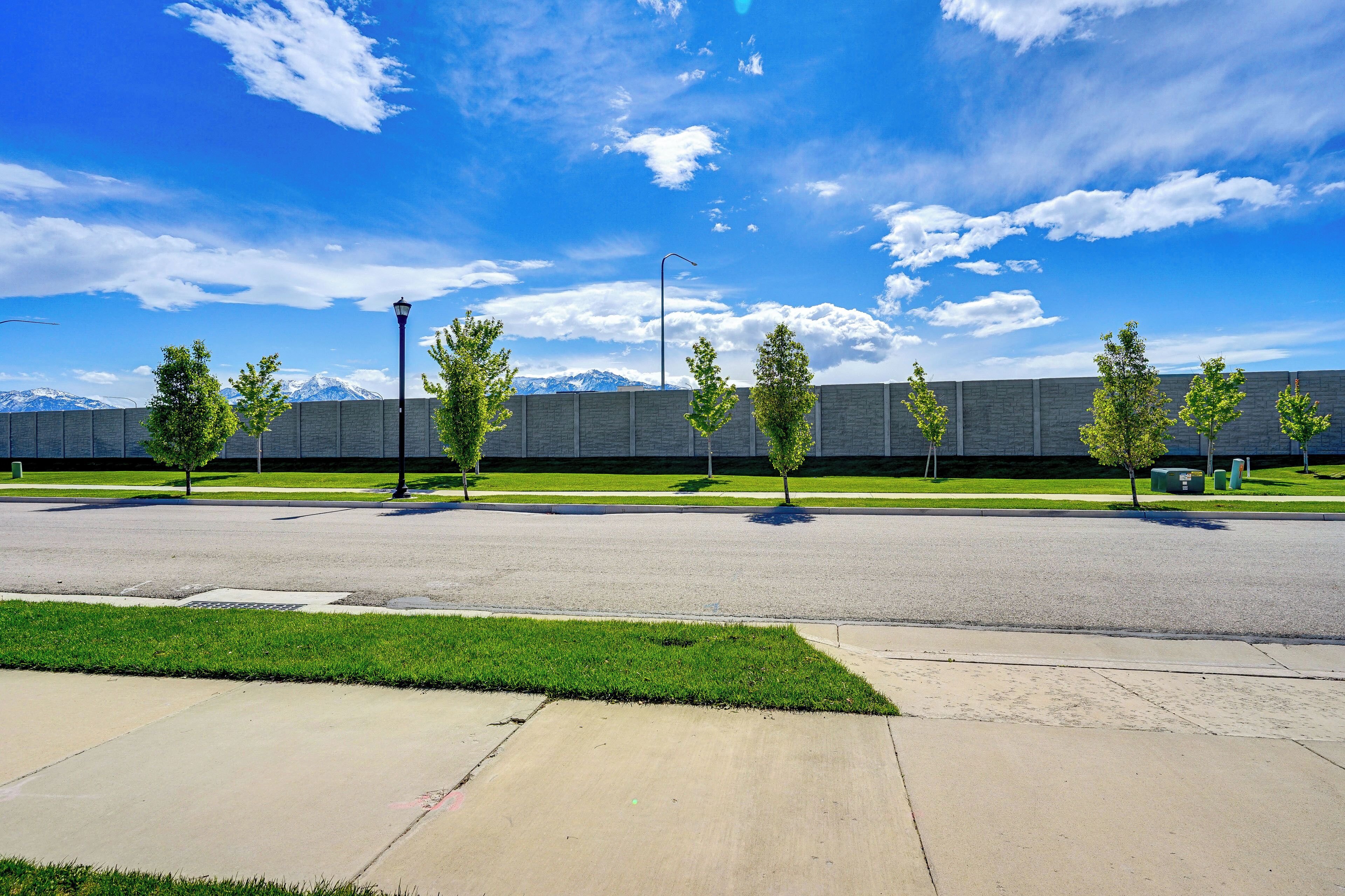 A wide, open parking area with a clear sky and distant mountains.