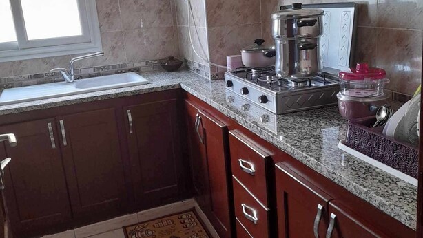 A kitchen with a gas stove, a sink, and a window. - Super Appartement S+2 Spacieux au Cœur de Bizerte (Bizerte)