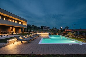 Relax by the pool surrounded by comfortable sun loungers.