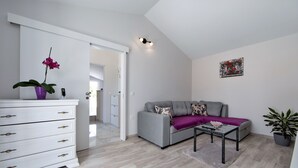 A modern living room with a grey sofa, a white dresser, and a coffee table. - Villa Silencio with pool (Tucepi)