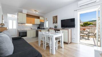 Apartment (One Bedroom Apartment with Balcony an) | Living room | 32-inch flat-screen TV with cable channels