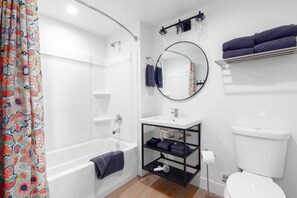 A bathroom with a shower, toilet, sink, and a mirror. - New! Your Mountain Town Getaway #7 (Mammoth Lakes)