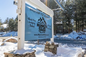 A sign for Mammoth Hutte with a call to action to book lodging.