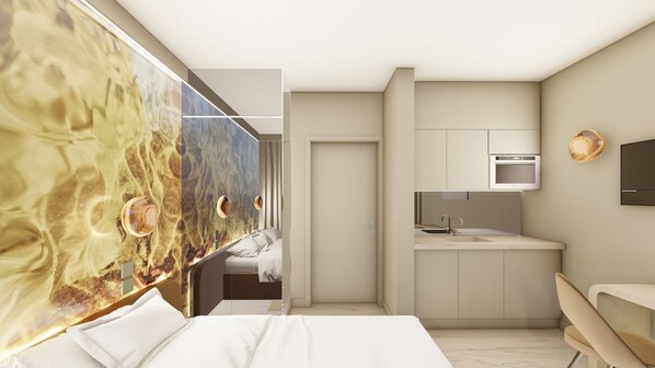 A modern hotel room with a bed, a small kitchenette, and a bathroom.