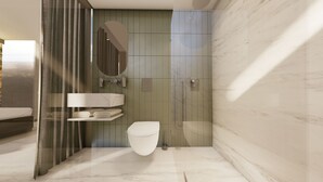 Un baño moderno con inodoro, lavabo y ducha.