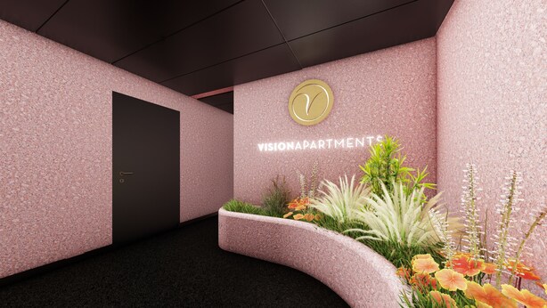 Un pasillo moderno con una puerta oscura, un letrero en la pared que dice "VISIONAPARTMENTS" y un arreglo decorativo de plantas.