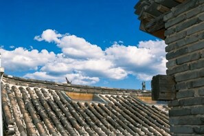 A traditional tiled roof with a clear sky and clouds. - Lijiang Wuge Inn (Lijiang)
