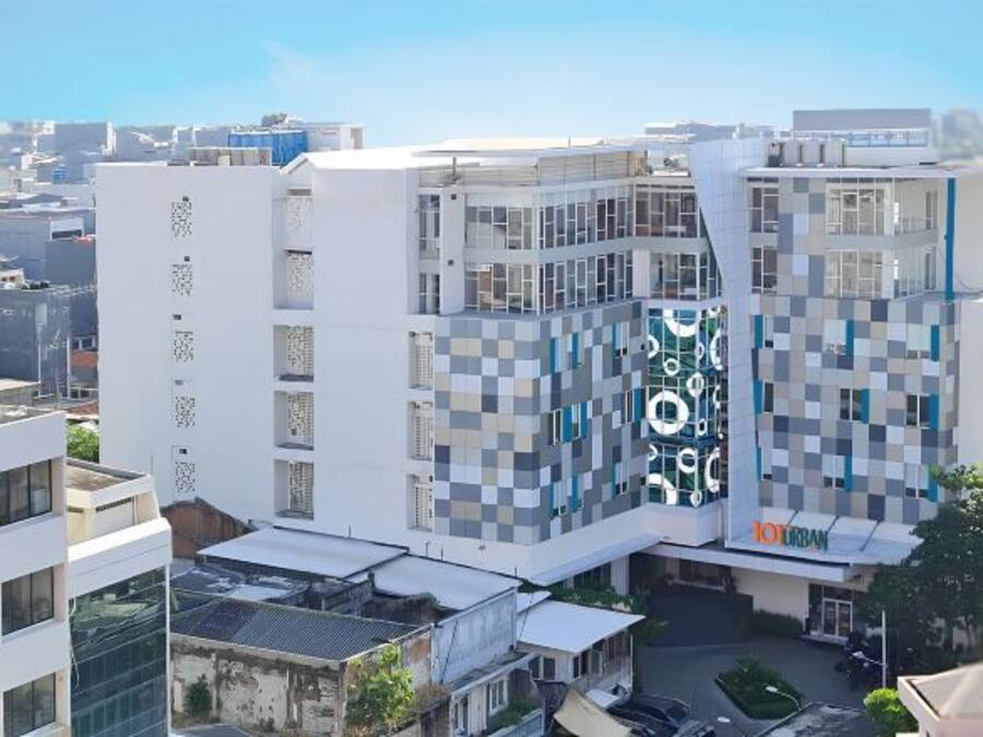 A modern building with a checkered facade, a visible 'TOURBAN' sign, and a clear view of the surrounding urban area.