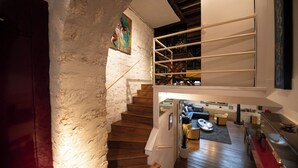 A staircase leading to a loft area with a wooden floor and a white wall. - Your stay in the heart of Paris in a large duplex apartment. Saint Germain (Paris)