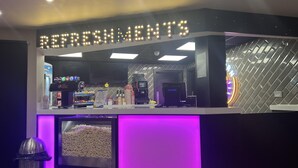 A refreshment kiosk with a neon sign, a beverage dispenser, and a snack display. - Immaculate 3-bed Static Caravan in Skegness (Skegness)