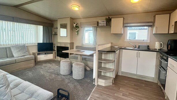 A compact RV interior with a living area, kitchenette, and a dining space. - Immaculate 3-bed Static Caravan in Skegness (Skegness)