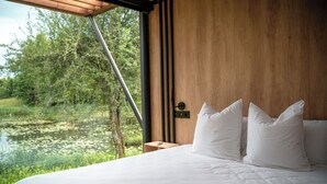 A bedroom with a large window overlooking a natural landscape. - Bleu Minuit - La Rive Etoilée (Plateau d'Hauteville)