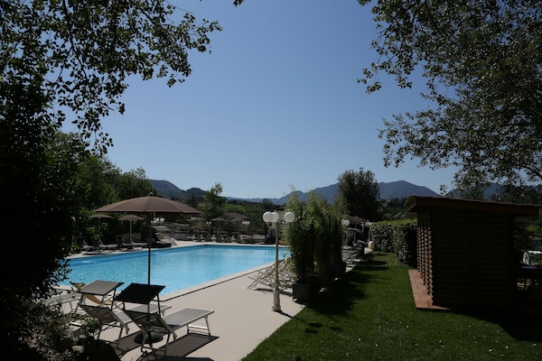 Seasonal outdoor pool, open 10:00 AM to 6:00 PM, pool umbrellas