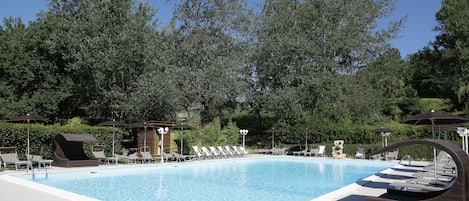 Seasonal outdoor pool, open 10:00 AM to 6:00 PM, pool umbrellas