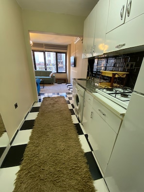 Mini-fridge, cookware/dishes/utensils, cleaning supplies