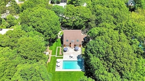 A house with a swimming pool surrounded by lush greenery. - Newly Renovated, Centrally Located East Hampton Home, Total Privacy,... (East Hampton)