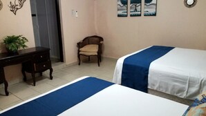A bedroom with two beds, a desk, a chair, and a potted plant. - Depa una recamara en la playa (Bucerías)
