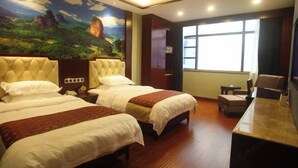 A hotel room with two beds, a large mural, a desk, and a window. - Xinning Xiaobaihua Resort Hotel (Xinning)