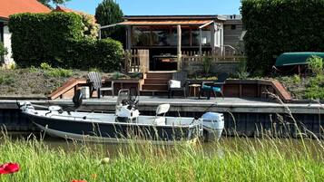 Enjoy waterfront relaxation with a dock and garden area, perfect for boating and socializing.