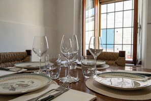 A dining table set with plates, glasses, and cutlery.