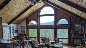 A spacious loft with high ceilings, large windows, and a cozy seating area with a fireplace. - Private, light filled retreat space...
     with your own pickleball court! (Berkeley Springs)