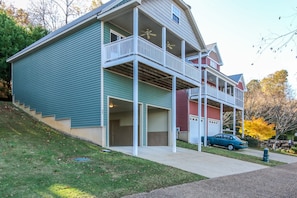 A two-story house with a balcony, a garage, and a driveway. - House # 26 Bay Bungalow (pet friendly) Lake View (Leesburg)