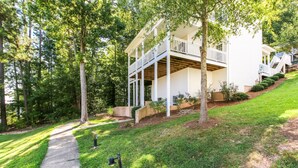 A two-story house with a front porch and a covered deck. - House #10 Paradise Found (pet friendly) private pier (Leesburg)