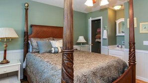 A four-poster bed with a wooden headboard and a patterned bedspread. - House #10 Paradise Found (pet friendly) private pier (Leesburg)