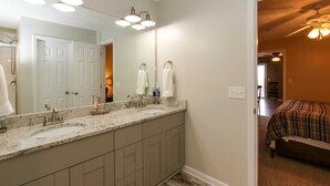 A bathroom with a double sink, a large mirror, and a vanity cabinet. - House# 30 Endless View Not Pet-Friendly (Leesburg)