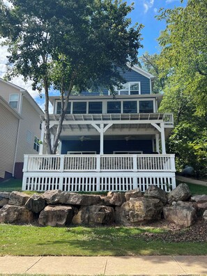 A two-story house with a covered front porch and a garage.
