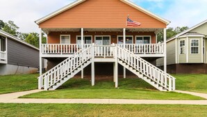A two-story building with a balcony and a flag. - House# 50 Home Away Home (No pets) (Leesburg)