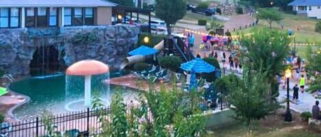 A resort with a water park, including a waterfall and slides.