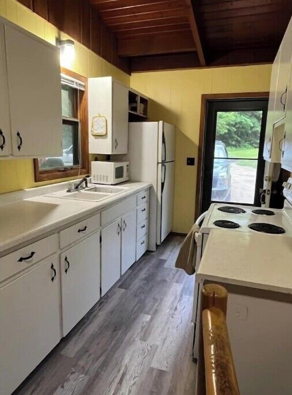 Enjoy cooking in this fully equipped kitchen with a sink, microwave, refrigerator, and stove.