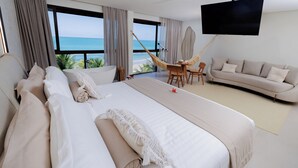 Habitación de hotel moderna con una cama grande, un sofá, una mesa de comedor y un televisor.