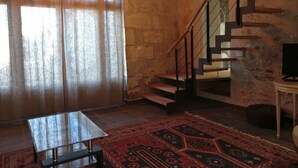 A room with a staircase, a glass table, and a patterned rug. - Chic and spacious self-catered loft cottage, ideal for work or romantic getaway (SOYAUX)