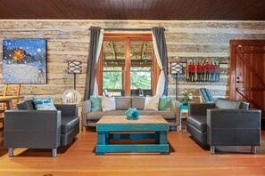 Relax in this inviting living room with a sofa, coffee table, and artwork.