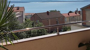 A balcony with a view of a calm sea and distant mountains. - Apartment Ana with sea view - Two Bedroom Apartment with Terrace and Sea View (Crikvenica)