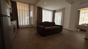 Deluxe Apartment, Garden View | Living area | 43-inch Smart TV with cable channels - Puglia Promenade Apartment 1 (Bari)