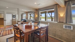 A spacious dining area with a large table, chairs, and a view of the outdoors. - *Riverfront*Pvt Dock*Game Room*6 mins to Beach* (Nehalem)