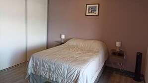 A bedroom with a bed, bedside tables, and a picture on the wall. - Prime loft | skyline views | dedicated workspace (San José)