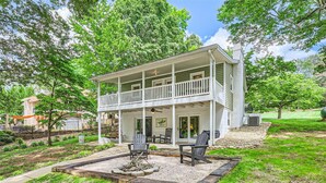 A two-story house with a balcony, a fire pit, and outdoor seating. - Locke Haven (Sherrills Ford)
