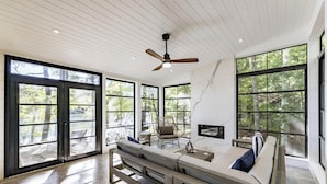 A spacious room with large windows, a ceiling fan, and a wooden bench. - 4bed, 4bath, South exp, prestigious area of Royal Muskoka Island w/road access (Minett)