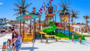A water park with a splash zone, slides, and a play structure. - Ocean Lakes New Build, Steps to Beach and Balcony! (Myrtle Beach)