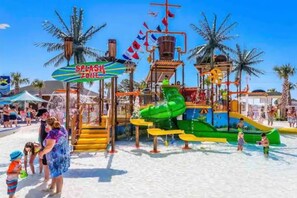 A water park with a splash zone, slides, and a play structure. - Ocean Lakes New Build, Steps to Beach and Balcony! (Myrtle Beach)