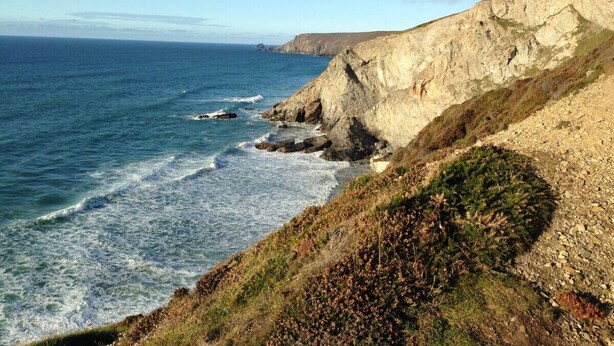 A coastal landscape with cliffs and the ocean.
