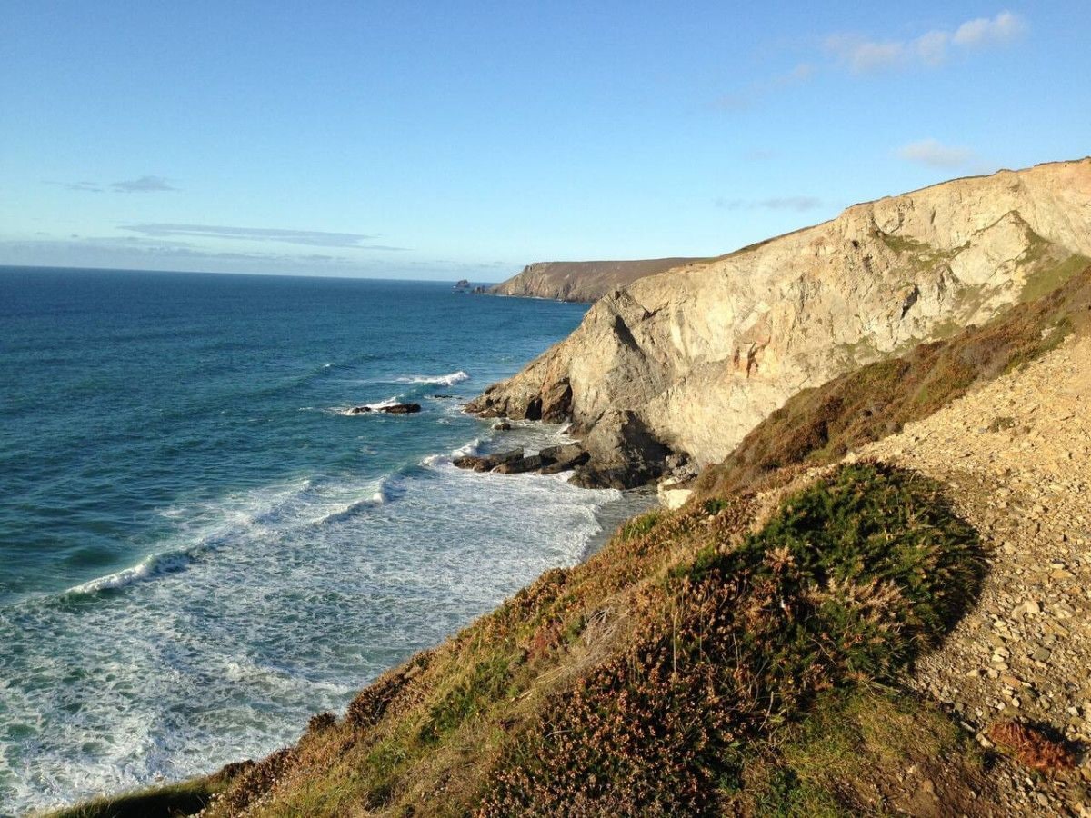 A coastal landscape with cliffs and the ocean.