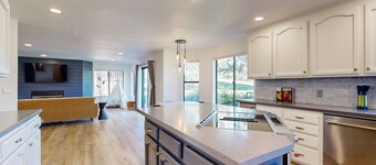 Two-story golf course-adjacent getaway with a patio, washer/dryer, central AC