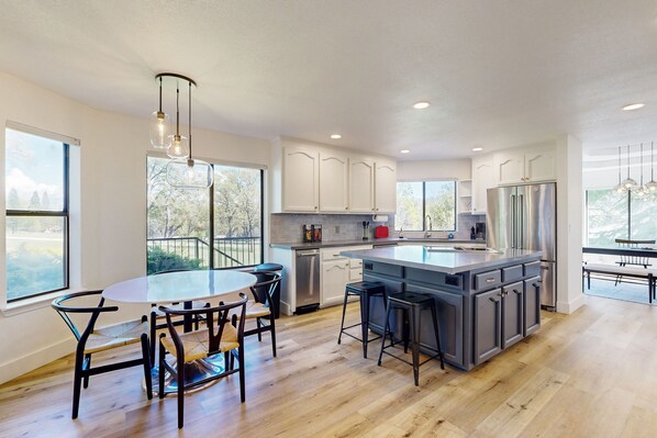 Enjoy cooking in this kitchen with a central island, bar stools, and ample counter space.