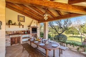 Enjoy a meal in a charming outdoor setting surrounded by a well-maintained garden.