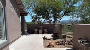 A concrete patio area with a view of trees and distant mountains. - Desert Oasis Retreat (Rio Rico)